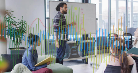 Gesturing presenter in plaid shirt, trousers pointing at mobile whiteboard charts in office lounge....
