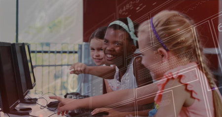 Pointing four girls leaning forward at monitors in school computer lab, with keyboards and mice. Collaboration, education, youth, technology, teamwork, learning, kidsの写真素材