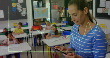 Presenting teacher holding tablet and overlaying charts while students writing in class, copy space. Education, classroom, learning, technology, collaboration, literacy, academicの写真素材