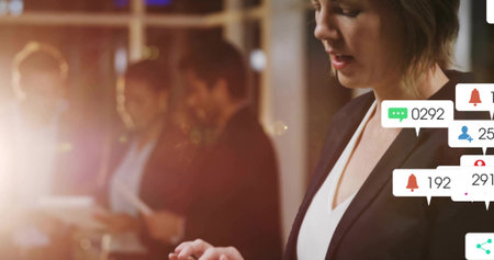 Tapping smartphone woman in black blazer using digital notifications at office lounge, copy space. Professional, modern, sleek, corporate, communication, network, collaborativeの写真素材