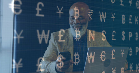 Checking smartphone, mature man analyzing market at office desk, with laptop and currency symbols. Finance, technology, digital, investment, business, analytics, modernの写真素材