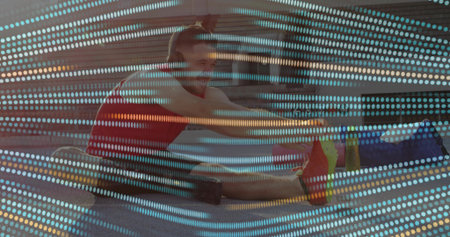 Performing seated hamstring stretch man in bright red tank top on urban plaza with grid overlay. Fitness, urban recreation, digital art, athleticism, modern design, motivation, outdoor activityの写真素材