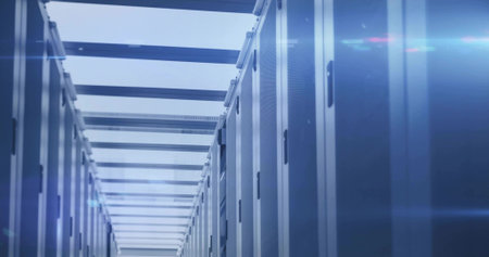 Extending rows of server cabinets forming narrow data center aisle, with mesh doors and status LEDs....