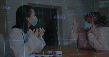 Masked doctor wearing lab coat and patient discussing health in clinic with thermometer, blue grid. Medical, consultation, data, technology, healthcare, professionalism, diagnosticの写真素材
