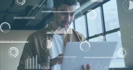 Holding laptop, tech professional analyzing floating data overlays inside office, visualization....