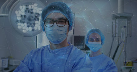 Operating surgeon wearing surgical attire in OR with overhead light monitors and network overlay. Medical, healthcare, precision, innovation, professionalism, teamwork, clinicalの写真素材