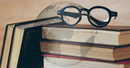 Resting black eyeglasses on hardcover book stack on desk, with digital globe overlay. Literature,...