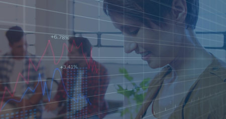 Smiling woman in tan blazer reviewing overlaid floating graphs in office with tablet and smartphone....