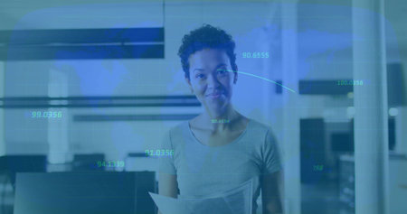 Office analyst holding documents wearing fitted gray top analyzing data overlays in office interior....