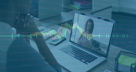 Sitting man facing laptop showing colleague chatting at office workspace with line graph overlay....