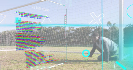 Kneeling athlete wearing sportswear at soccer goal net showing AI DATA MINING overlays, copy space. Sports, technology, cyber, innovation, digital, interface, landscapeの写真素材