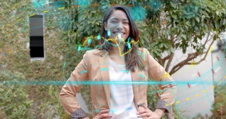 Standing woman wearing tan blazer and white top in courtyard, with holographic waveform graphics. Futuristic, technology, professionalism, outdoor, digital, innovation, contemporaryの写真素材