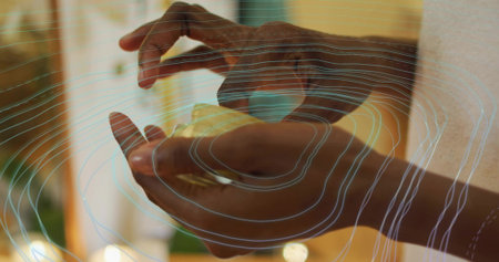 Dark-skinned hands holding and positioning sensor patch in clinic, with digital contour overlay. Biometric, technology, innovation, healthcare, futuristic, minimalism, precisionの写真素材