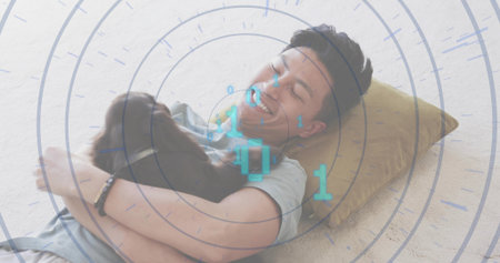 Man wearing gray shirt hugging small brown dog on home carpet, with mustard pillow, binary overlay....