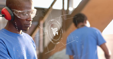 Carpenter in blue shirt wearing gear placing plywood in workshop, copy space. Craftsmanship,...
