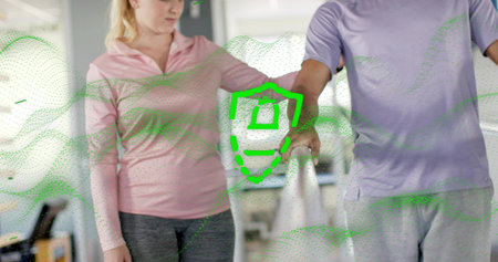 Guiding therapist helping pair in sportswear along parallel rail at rehab gym green graphic overlay....