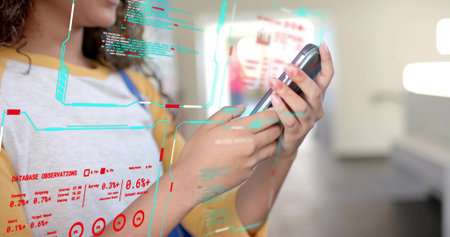 Interacting holographic overlays teen girl in yellow shirt overalls holding smartphone in tech lab. Futuristic, innovation, youthful, technology, digital, interface, brightの写真素材