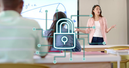 Gesturing teacher in pink shirt explaining whiteboard diagram in classroom with padlock, copy space. Educational, teaching, learning, classroom, presentation, digital, technologyの写真素材