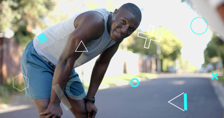 Pausing runner bending hands-on-knees on suburban street, wearing athletic wear, watch, overlays....