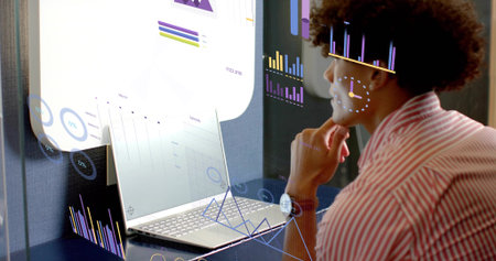 Leaning data analyst in striped shirt analyzing AR overlays at office desk, with laptop, copy space....