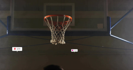 Showing basketball hoop with orange rim, white net inside gym. Sports, fitness, recreation, arena, competition, active, dynamicの写真素材