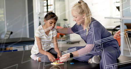 Therapist in navy scrubs guiding child wearing striped shirt on black mat with pegboard at clinic. Pediatric, rehab, caregiver, play, motor, interaction, sunlitの写真素材