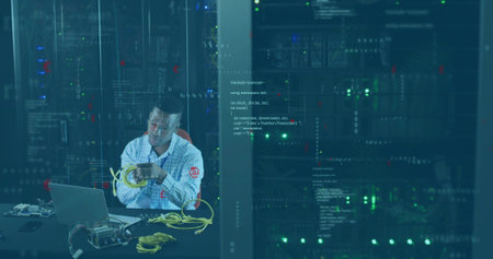 IT technician arranging Ethernet cables in server room racks with laptop, switch, copy space....