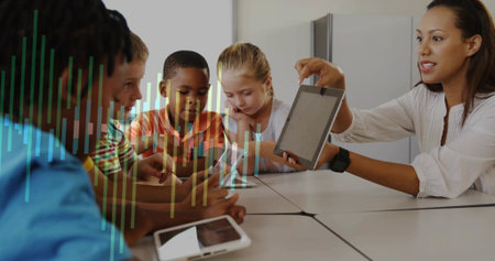 Displaying instructor holding tablet toward students at classroom table, graph overlay, copy space....