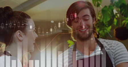 Smiling cafe staff wearing dark aprons discussing data at counter, with plants and chart overlay. Collaboration, productivity, freshness, rustic, modern, teamwork, hospitalityの写真素材