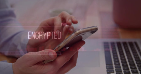 Tapping smartphone screen with shirt sleeves above desk, showing laptop mug and encrypted overlay. Technology, cybersecurity, professional, productivity, modern, business, digitalの写真素材