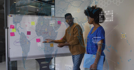 Pointing man and listening woman holding folder at office whiteboard, with sticky notes and markers. Collaboration, teamwork, brainstorming, innovation, strategy, business, officeの写真素材