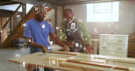 Two mature carpenters aligning wooden board in woodshop, with tape measure, ruler and digital icons....