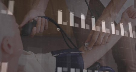 Measuring medical provider in scrubs inflating cuff on patient arm in exam room, bar chart graphics. Healthcare, diagnostics, medical, technology, professionalism, data visualization, patient careの写真素材