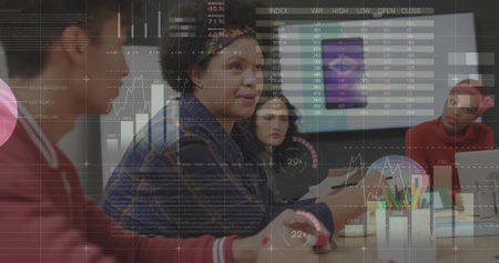 Presenting woman in denim jacket gesturing toward financial charts in modern office, with display. Collaboration, teamwork, data analysis, business meeting, modern workspace, professional settingの写真素材