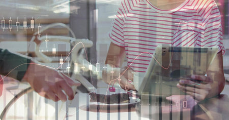 Sitting woman holding tablet and mug at cafe table, with cake slice and financial charts overlay. Modern, professional, minimalist, workspace, digital, sophistication, lifestyleの写真素材