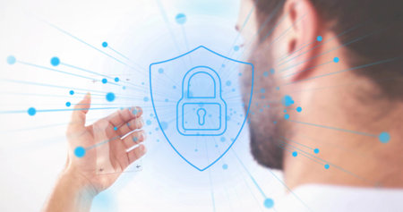 Reaching man in shirt extending hand toward floating blue shield padlock in studio, with nodes....