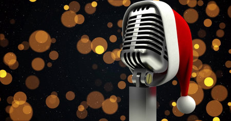 Image of yellow spots over microphone with santa hat. Christmas, celebration and digital interface concept digitally generated image.の写真素材