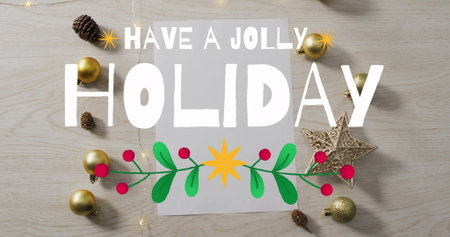 Have jolly holiday text image over Christmas decorations on wooden background. festive, celebration, seasonal, merry, joyful, greetingの写真素材