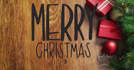 Merry Christmas text image over wooden background with gifts and decorations. holiday, celebration, festive, seasonal, presents, ornamentsの写真素材