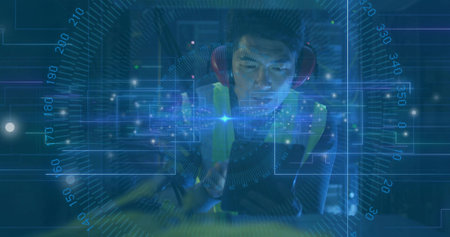 Monitoring data via HUD overlay, man wearing safety vest and earmuffs using tablet in factory. Industrial, technology, safety, digital, expertise, modern, engineeringの写真素材