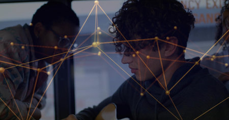 Curly-haired man playing acoustic guitar in studio, with glasses-wearing student and network lines. Music, collaboration, creativity, innovation, urban, minimalist, teamworkの写真素材