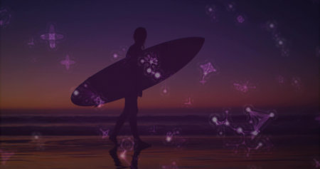 Walking silhouette surfer carrying surfboard on wet sand shore at dusk, with glowing constellations. Silhouette, coastline, twilight, serenity, celestial, reflection, adventureの写真素材