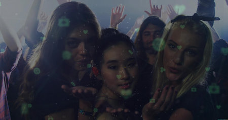 Sending kisses friends leaning toward camera at club, heart camera icons, strobe lights, wristbands. Party, nightlife, celebration, friendship, glamour, energy, modernの写真素材