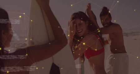 Laughing central woman holding white surfboard on sandy beach, with red bikini top board shorts. Beach, recreation, summer, outdoor, leisure, vibrant, socialの写真素材