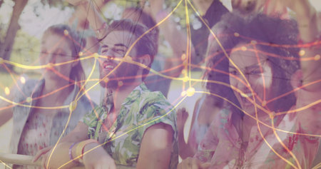 Leaning man wearing tropical shirt on barrier at festival, with wristbands and glowing streaks. Concert, festival, leisure, youth, celebration, outdoor, vibrantの写真素材