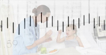 Feeding nurse in blue scrubs leaning over hospital bed at pediatric ward, with spoon and bowl. Healthcare, caregiving, pediatric, medical, compassion, wellness, clinicalの写真素材