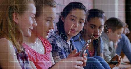 Sitting row of six students focusing on smartphones in learning space, with digital chart overlay. Technology, education, youth, innovation, communication, digital, collaborationの写真素材