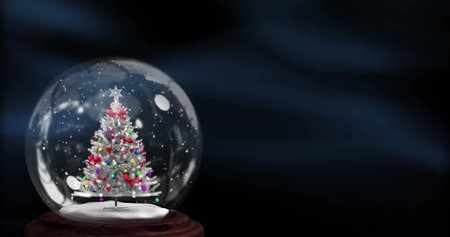 Image of christmas tree in snow globe over blue shapes. Christmas, celebration and digital interface concept digitally generated image.の写真素材