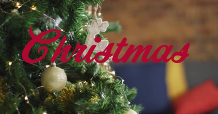 Christmas text image over decorated tree with ornaments and lights. decoration, festive, holiday, celebration, seasonal, glowingの写真素材