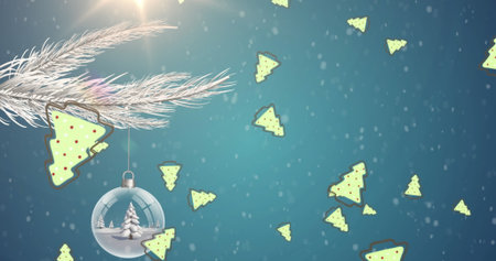 Christmas tree icons falling against christmas decorations hanging on tree branch on blue background. christmas festivity and celebration conceptの写真素材
